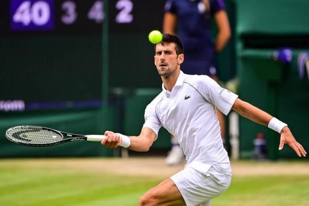 Novak Djokovic of Serbia hits a forehand against Marton Fucsovics of Hungary in the quarter finals of the gentlemen's singles during Day Nine of The...