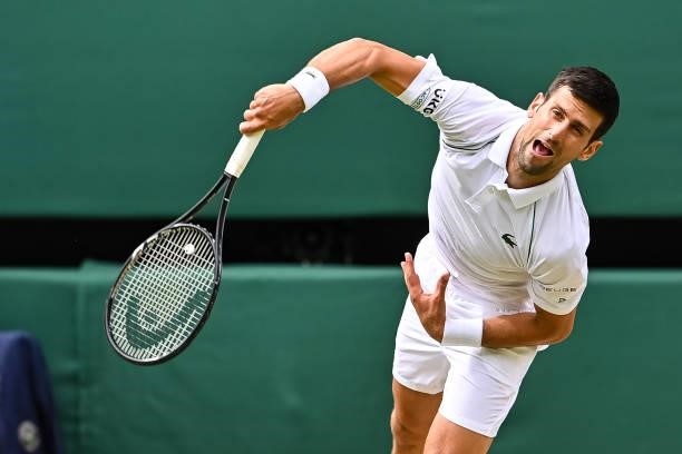 Novak Djokovic of Serbia serves against Marton Fucsovics of Hungary in the quarter finals of the gentlemen's singles during Day Nine of The...