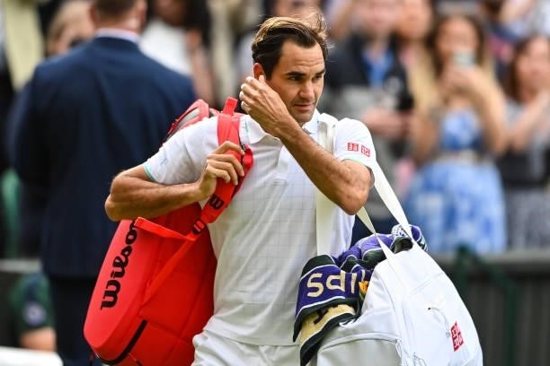 Roger Federer of Switzerland leaves centre court after his loss to Hubert Hurkacz of Poland in the quarter finals of the gentlemen's singles during...