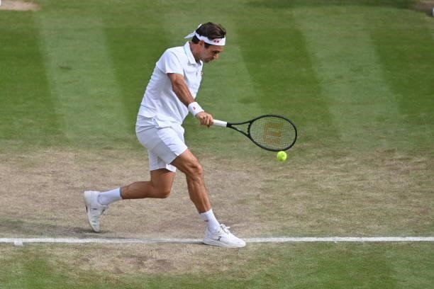Roger Federer of Switzerland hits a backhand against Hubert Hurkacz of Poland in the quarter finals of the gentlemen's singles during Day Nine of The...