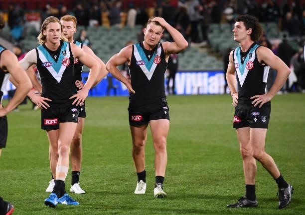 Miles Bergman ,Ollie Wines and Darcy Byrne-Jones of Port Adelaide dejected after losing the round 17 AFL match between Port Adelaide Power and...
