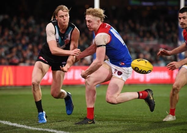 Miles Bergman of Port Adelaide handballs past Clayton Oliver of the Demons during the round 17 AFL match between Port Adelaide Power and Melbourne...