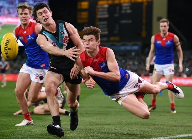 Bailey Frisch of the Demons handballs past Darcy Byrne-Jones of Port Adelaide during the round 17 AFL match between Port Adelaide Power and Melbourne...