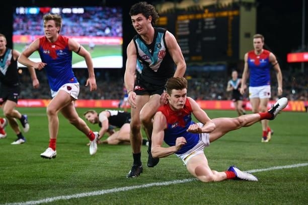 Bailey Frisch of the Demons handballs past Darcy Byrne-Jones of Port Adelaide during the round 17 AFL match between Port Adelaide Power and Melbourne...