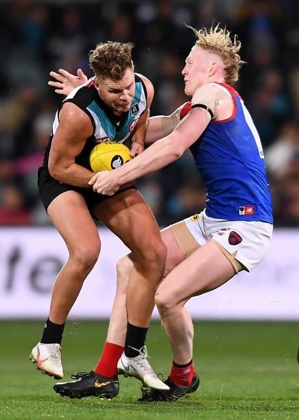 Dan Houston of Port Adelaide tackled by Clayton Oliver of the Demons during the round 17 AFL match between Port Adelaide Power and Melbourne Demons...