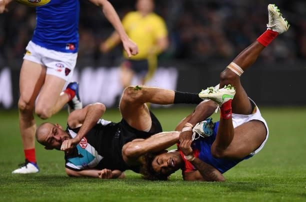 Jarrod Lienert of Port Adelaide tackled by Kysaiah Pickett of the Demons during the round 17 AFL match between Port Adelaide Power and Melbourne...