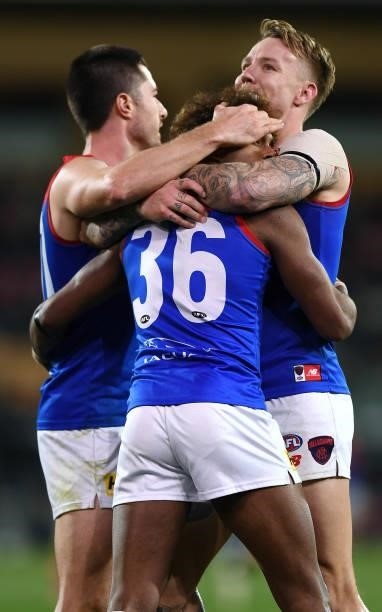Kysaiah Pickett of the Demons celebrates a goal with Alex Neal-Bullen and James Harmes of the Demons during the round 17 AFL match between Port...