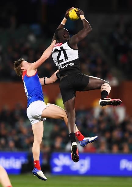 Aliir Aliir of Port Adelaide marks in front of Charlie Spargo of the Demons during the round 17 AFL match between Port Adelaide Power and Melbourne...