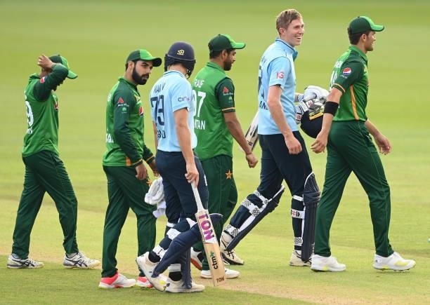 Zac Crawley and Dawid Malan of England leave the field with Pakistan players after England won the first One Day international between England and...