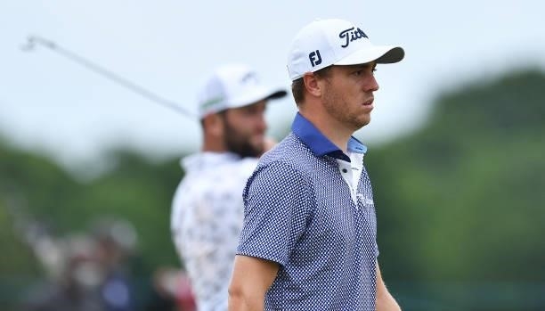 Justin Thomas of the United States and Jon Rahm of Spain look on during Day One of the abrdn Scottish Open at The Renaissance Club on July 08, 2021...