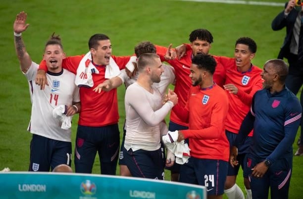 Luke Shaw and Reece James greet each other as Kalvin Phillips, Conor Coady, John Stones, Tyrone Mings, Jude Bellingham and coach Chris Powell...