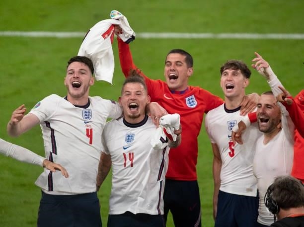 England players Declan Rice, Kalvin Phillips, Conor Coady, John Stones and Luke Shaw celebrate after the UEFA Euro 2020 Championship Semi-final match...