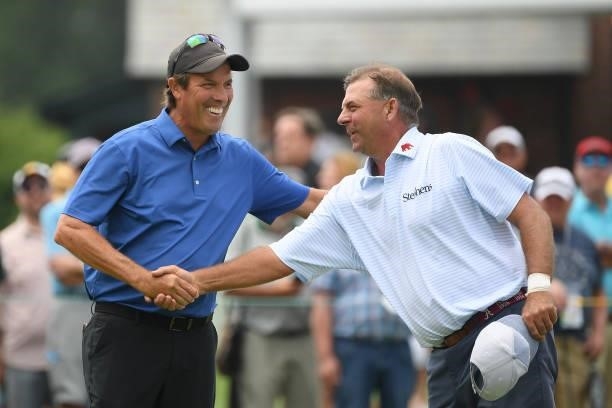 Stephen Ames of Canada and Dicky Pride shake hands after putting on the 18th hole during the first round of the U.S. Senior Open Championship at the...
