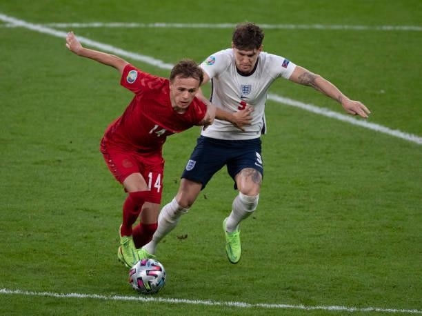 Mikkel Damsgaard of Denmark and John Stones of England in action during the UEFA Euro 2020 Championship Semi-final match between England and Denmark...