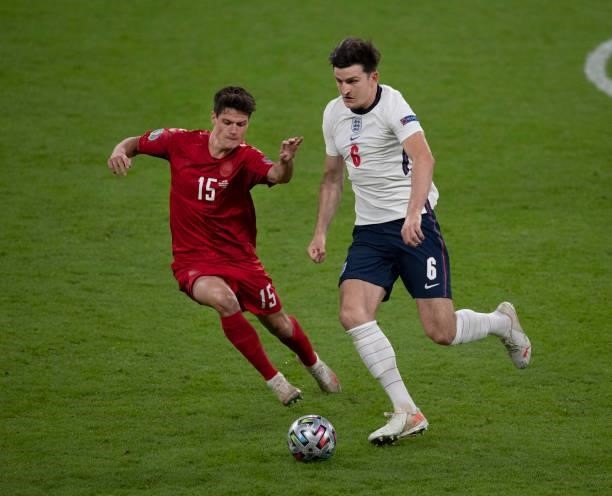 Harry Maguire of England and Christian Nørgaard of Denmark in action during the UEFA Euro 2020 Championship Semi-final match between England and...