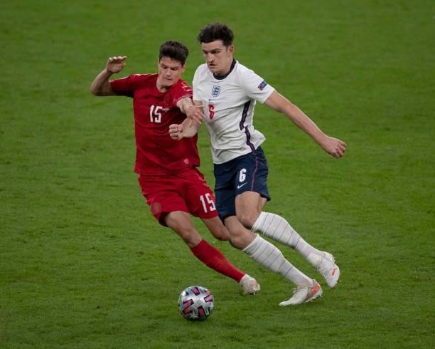 Harry Maguire of England and Christian Nørgaard of Denmark in action during the UEFA Euro 2020 Championship Semi-final match between England and...