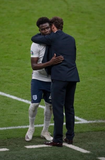 England manager Gareth Southgate greets Bukayo Saka after he is substituted during the UEFA Euro 2020 Championship Semi-final match between England...