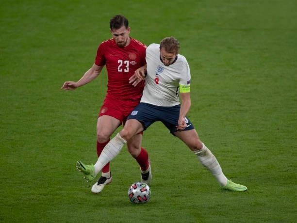 Harry Kane of England and Pierre-Emile Højbjerg of Denmark in action during the UEFA Euro 2020 Championship Semi-final match between England and...