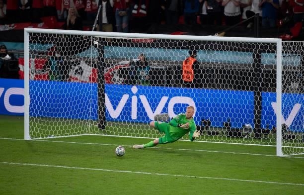 Denmark goalkeeper Kasper Schmeichel saves Harry Kane's penalty but he scores the rebound during the UEFA Euro 2020 Championship Semi-final match...