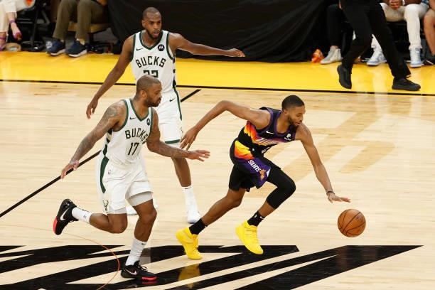 Mikal Bridges of the Phoenix Suns steals the ball from P.J. Tucker of the Milwaukee Bucks in the second half of game two of the NBA Finals at Phoenix...