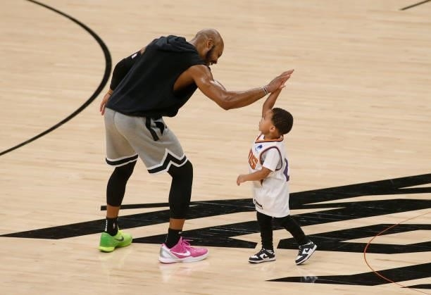 Jevon Carter of the Phoenix Suns high fives three-year old Langston "Deuce