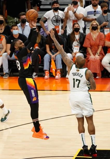Jae Crowder of the Phoenix Suns shoots over P.J. Tucker of the Milwaukee Bucks in the second half of game two of the NBA Finals at Phoenix Suns Arena...