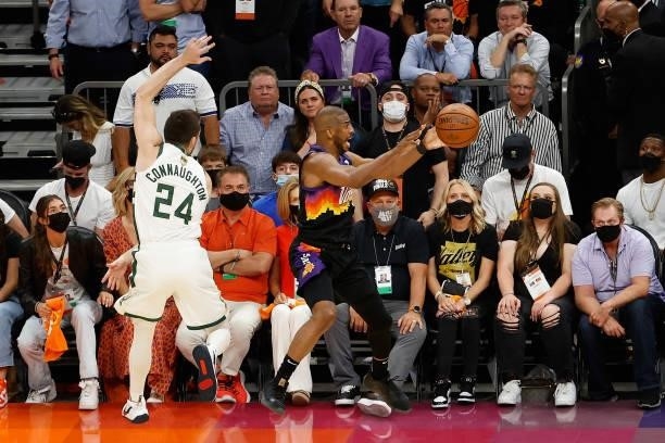 Chris Paul of the Phoenix Suns makes a leaping pass ahead of Pat Connaughton of the Milwaukee Bucks in the second half of game two of the NBA Finals...
