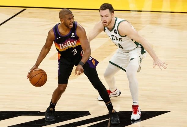 Chris Paul of the Phoenix Suns handles the ball against Pat Connaughton of the Milwaukee Bucks in the second half of game two of the NBA Finals at...