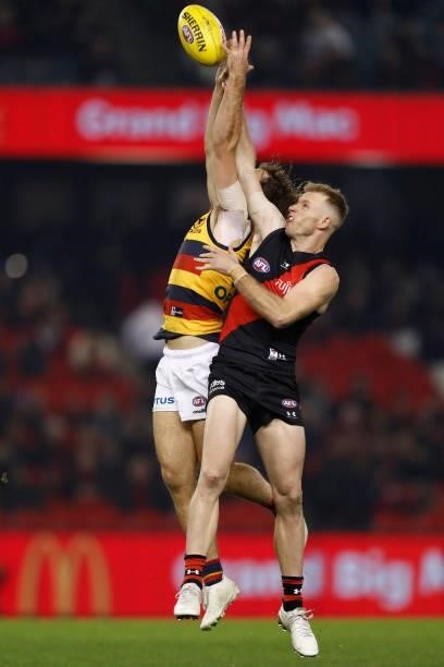 Luke Pedlar of the Crows and Nick Hind of the Bombers compete during the round 17 AFL match between Essendon Bombers and Adelaide Crows at Marvel...