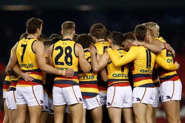 Adelaide Crows players huddle before the round 17 AFL match between Essendon Bombers and Adelaide Crows at Marvel Stadium on July 09, 2021 in...