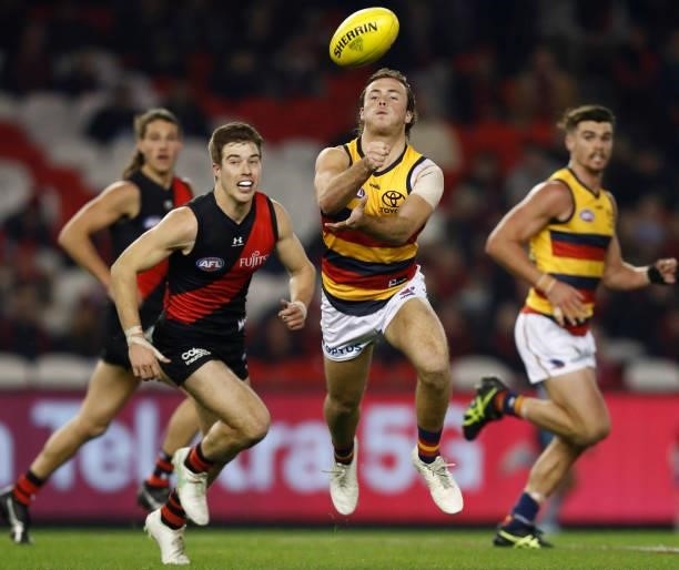 Luke Pedlar of the Crows handballs during the round 17 AFL match between Essendon Bombers and Adelaide Crows at Marvel Stadium on July 09, 2021 in...