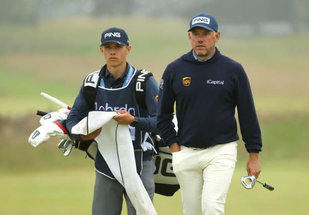 Lee Westwood of England with son and caddie Sam Westwood walk to the 18th green during Day Two of the abrdn Scottish Open at The Renaissance Club on...