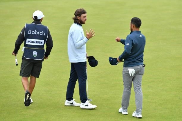 Xander Schauffele of the United States shakes hands with Tommy Fleetwood of England on the 18th green during Day Two of the abrdn Scottish Open at...