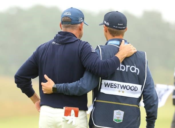 Lee Westwood of England with son and caddie Sam Westwood embrace on the 18th green during Day Two of the abrdn Scottish Open at The Renaissance Club...