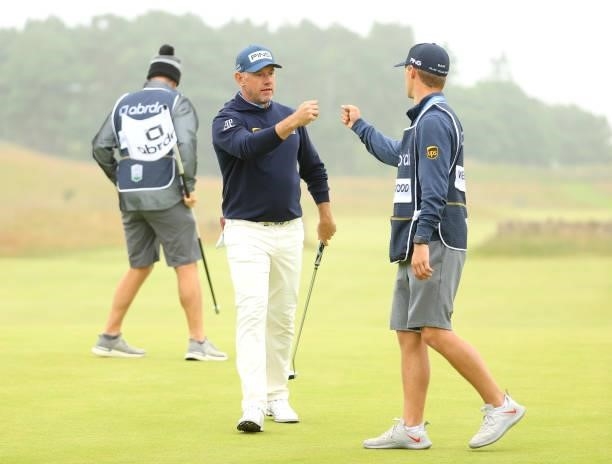 Lee Westwood of England with son and caddie Sam Westwood bump fists on the 18th green during Day Two of the abrdn Scottish Open at The Renaissance...