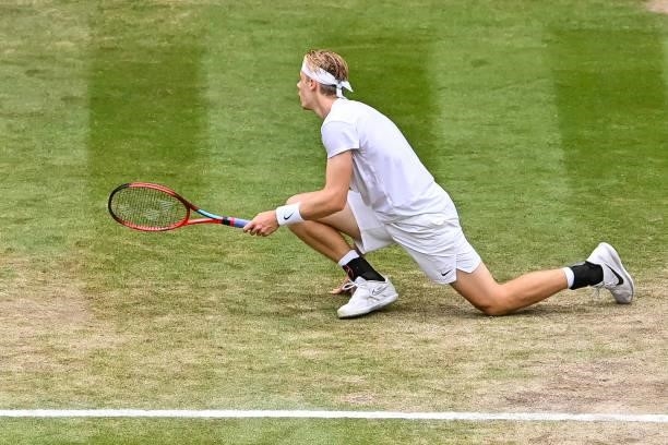 Dennis Shapovalov of Canada slips over during his match against Novak Djokovic of Serbia in the semi-finals of the gentlemen's singles during Day...