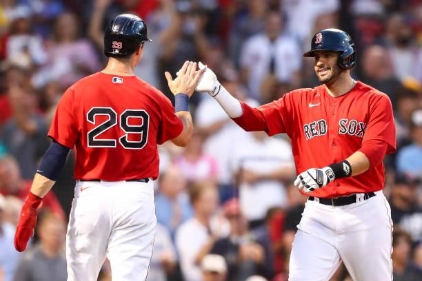 Martinez of the Boston Red Sox reacts with Bobby Dalbec of the Boston Red Sox after hitting a three-run home run in the second inning of a game...