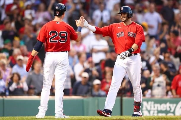 Martinez of the Boston Red Sox reacts with Bobby Dalbec of the Boston Red Sox after hitting a three-run home run in the second inning of a game...