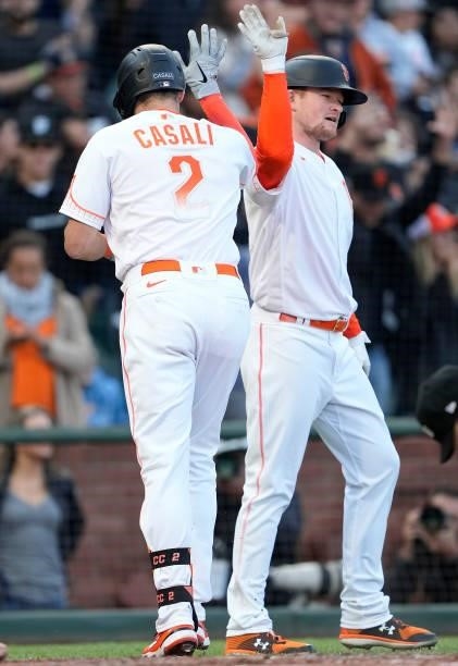 Curt Casali and Logan Webb of the San Francisco Giants celebrates after Casali hit a two-run home run against the Washington Nationals in the bottom...