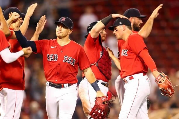 Enrique Hernandez of the Boston Red Sox high five teammates after a victory over the Philadelphia Phillies at Fenway Park on July 9, 2021 in Boston,...