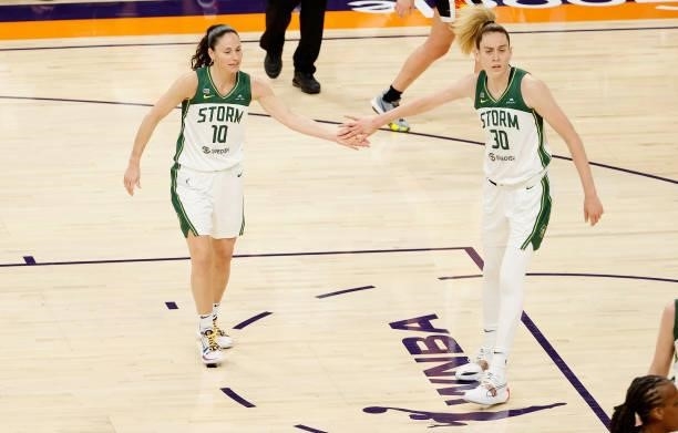 Sue Bird of the Seattle Storm high fives Breanna Stewart during the first half of the WNBA game against the Phoenix Mercury at Phoenix Suns Arena on...