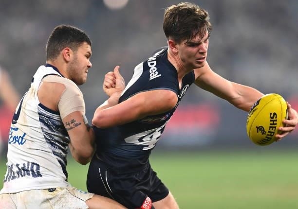 Paddy Dow of the Blues is tackled by Brandan Parfitt of the Cats during the round 17 AFL match between Carlton Blues and Geelong Cats at Melbourne...