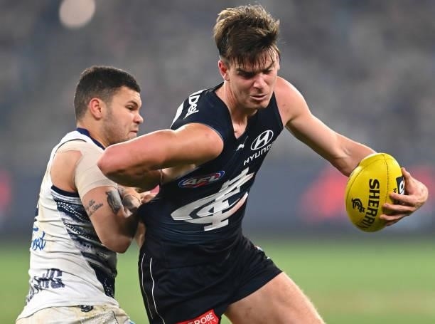 Paddy Dow of the Blues is tackled by Brandan Parfitt of the Cats during the round 17 AFL match between Carlton Blues and Geelong Cats at Melbourne...