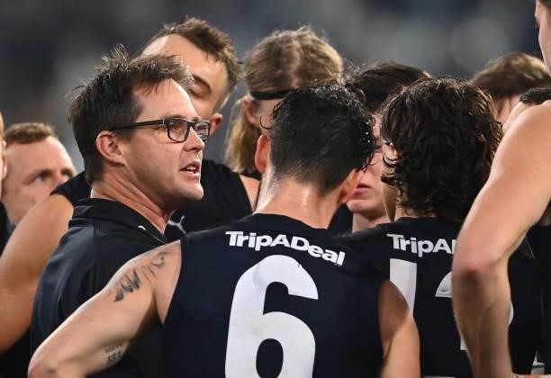 Blues head coach David Teague talks to his players during the round 17 AFL match between Carlton Blues and Geelong Cats at Melbourne Cricket Ground...