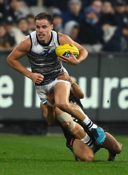 Jake Kolodjashnij of the Cats is tackled during the round 17 AFL match between Carlton Blues and Geelong Cats at Melbourne Cricket Ground on July 10,...