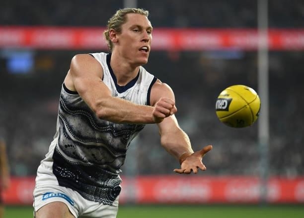Mark Blicavs of the Cats handballs during the round 17 AFL match between Carlton Blues and Geelong Cats at Melbourne Cricket Ground on July 10, 2021...