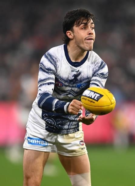 Brad Close of the Cats handballs during the round 17 AFL match between Carlton Blues and Geelong Cats at Melbourne Cricket Ground on July 10, 2021 in...