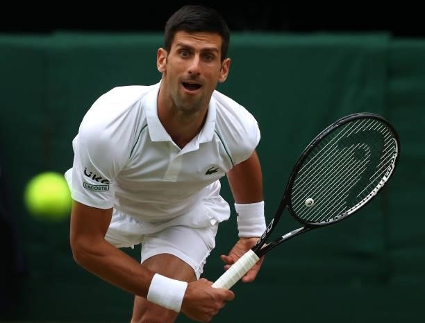 Novak Djokovic of Serbia serves in his Men's Singles Semi-Final match against Denis Shapovalov of Canada during Day Eleven of The Championships -...