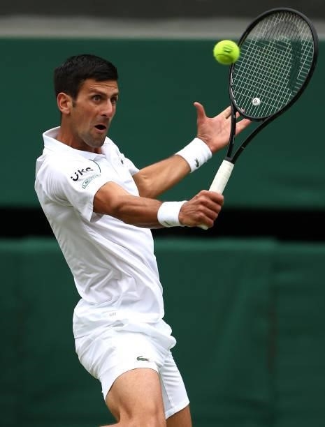 Novak Djokovic of Serbia plays a backhand in his Men's Singles Semi-Final match against Denis Shapovalov of Canada during Day Eleven of The...