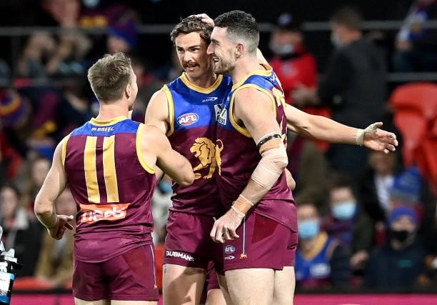 Joe Daniher of the Lions is congratulated by team mates after kicking a goal during the round 17 AFL match between Brisbane Lions and St Kilda Saints...